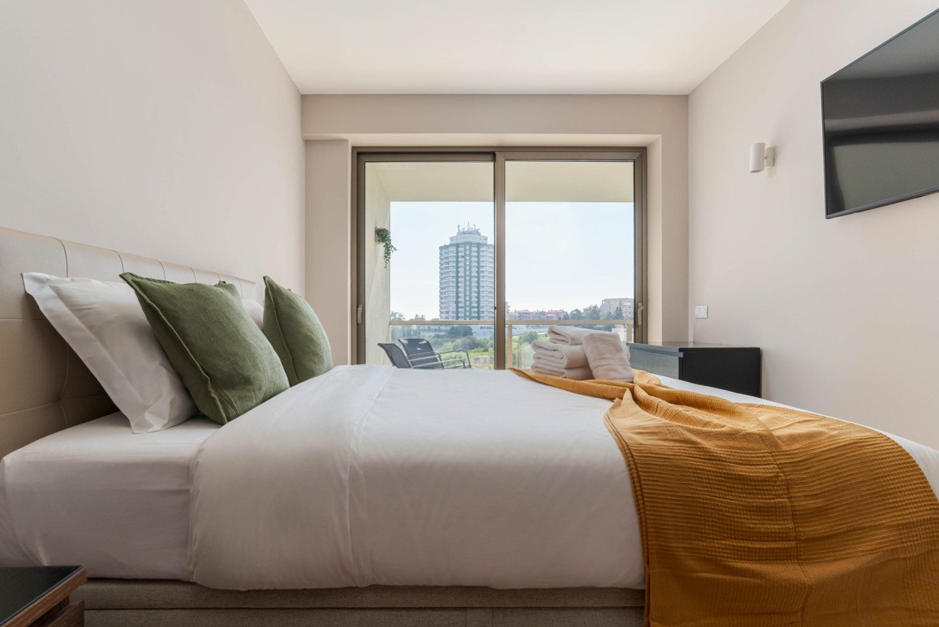 Bedroom with balcony city view