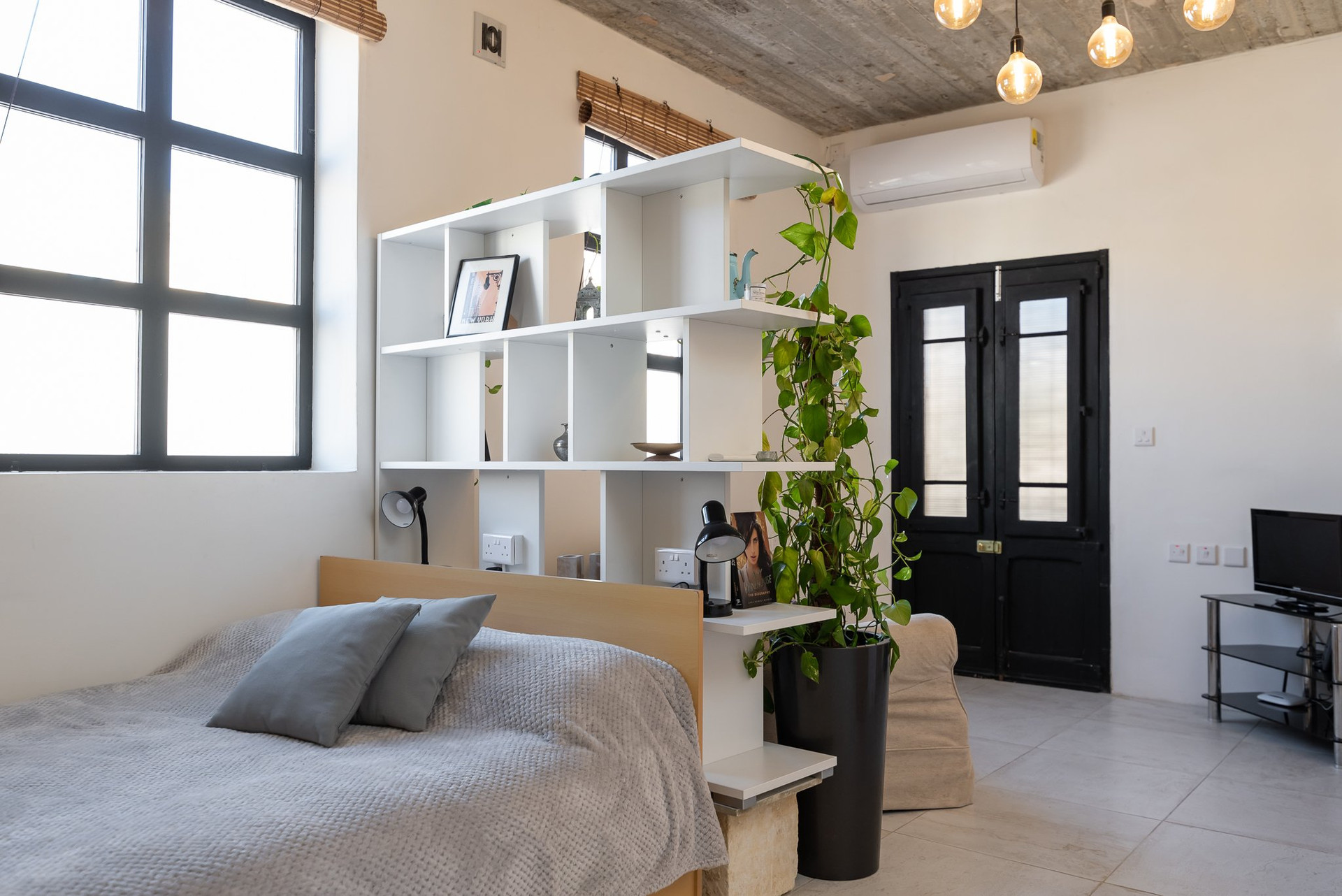 Bedroom with shelving and plants