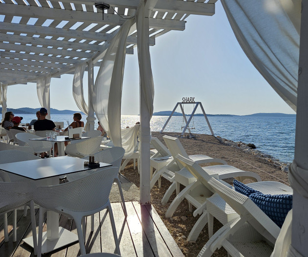 Beach cafe seating by shore