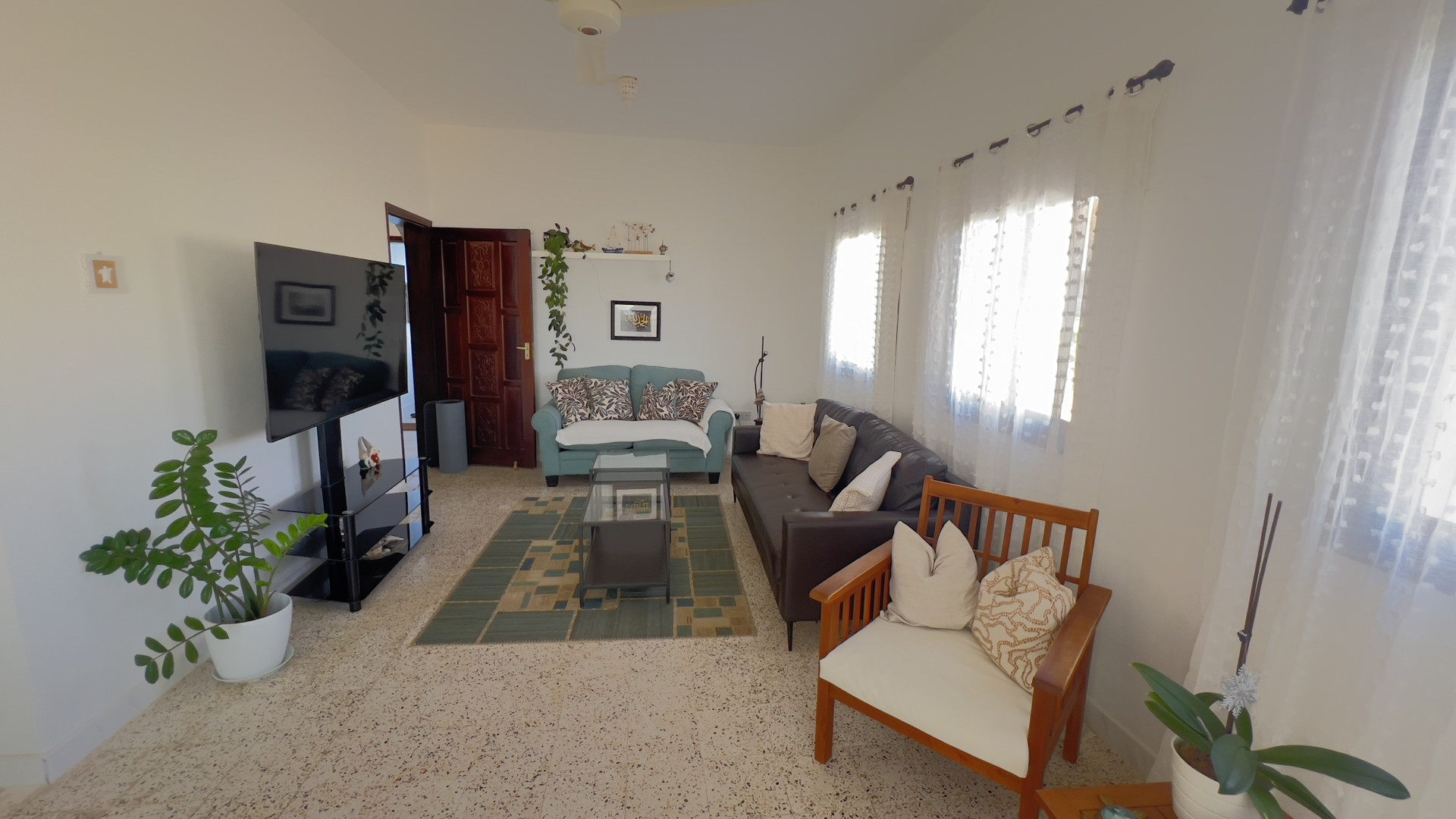 Spacious living room with TV