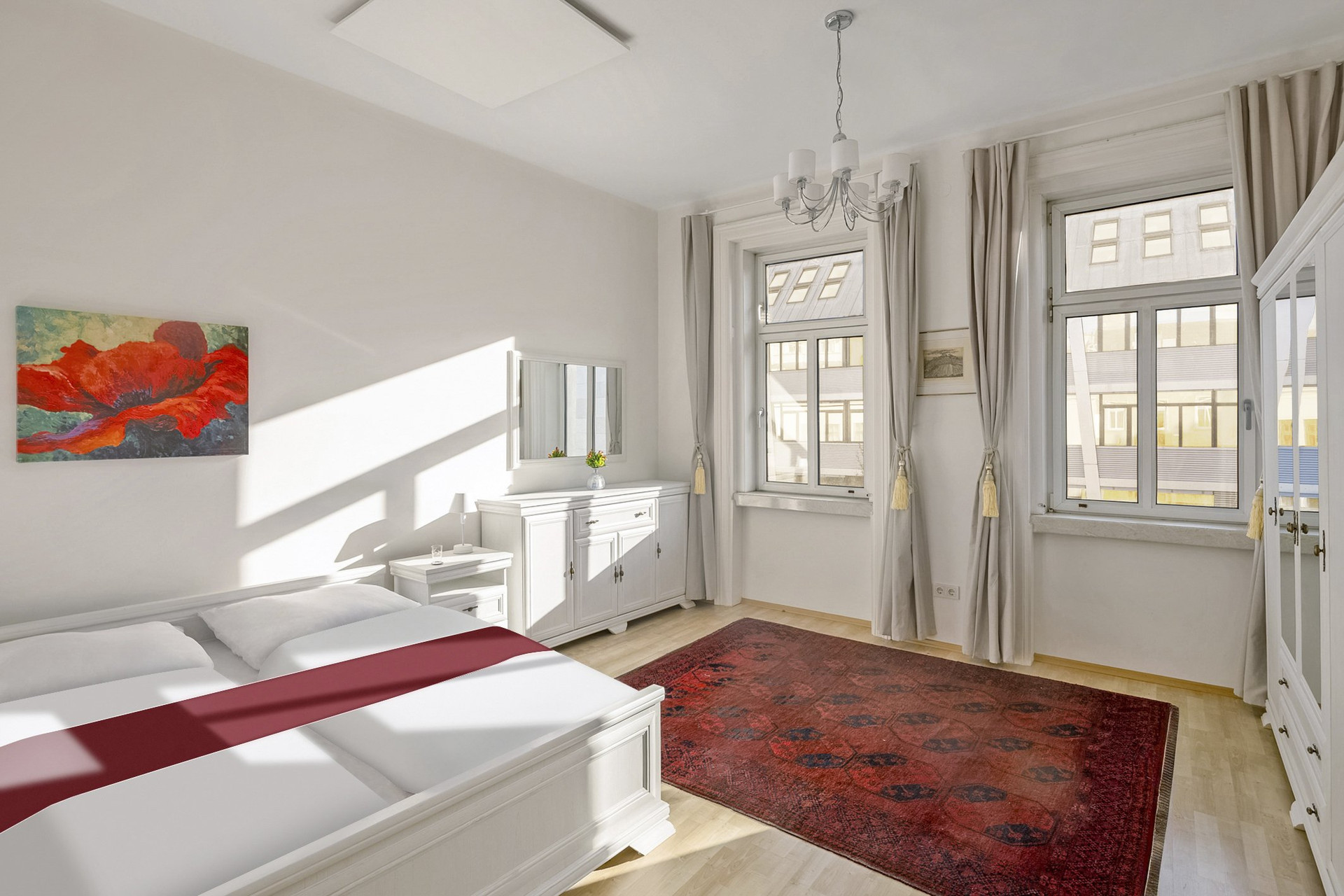 Bedroom with double bed, red rug