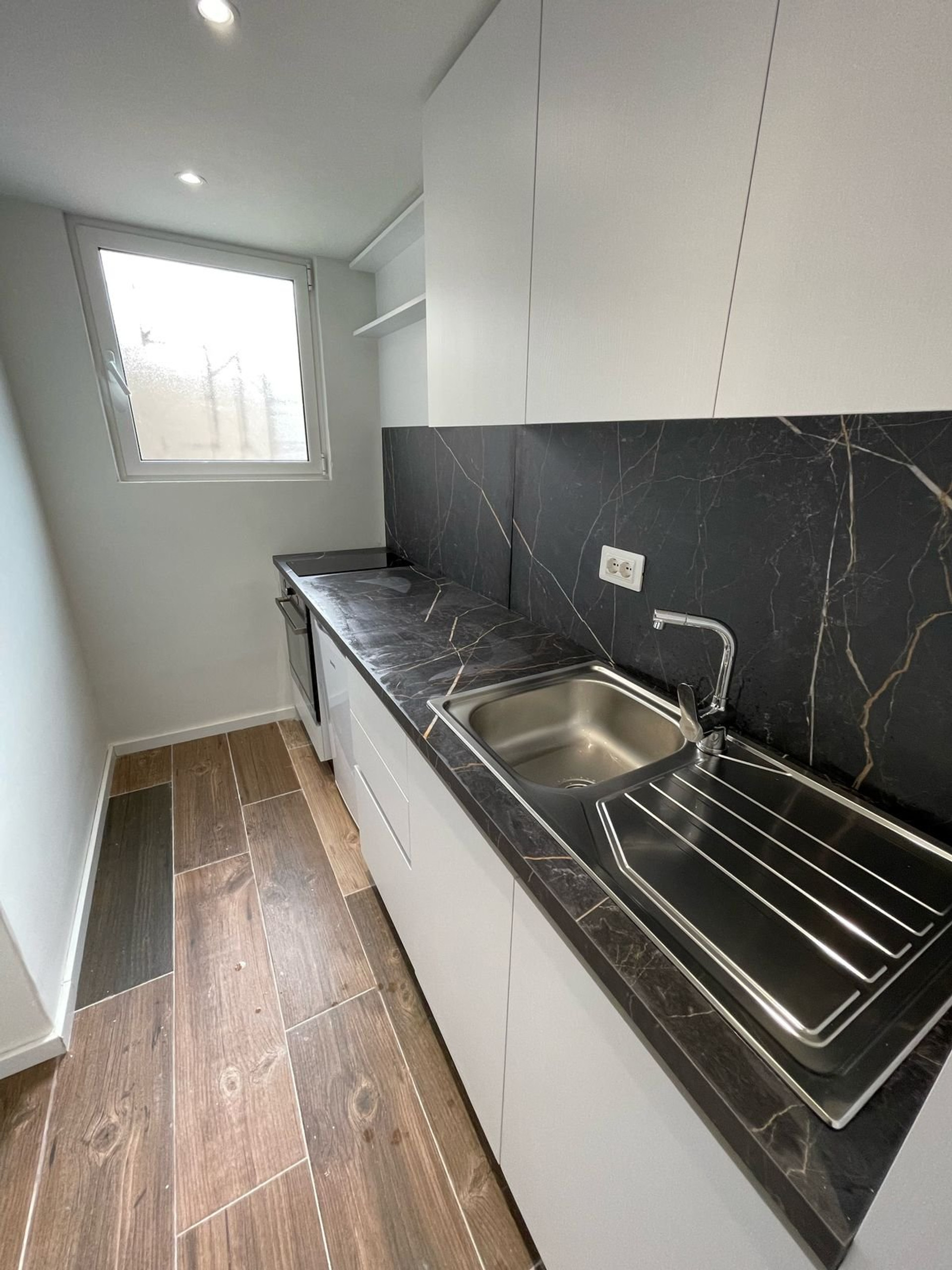Kitchen with marble backsplash and sink