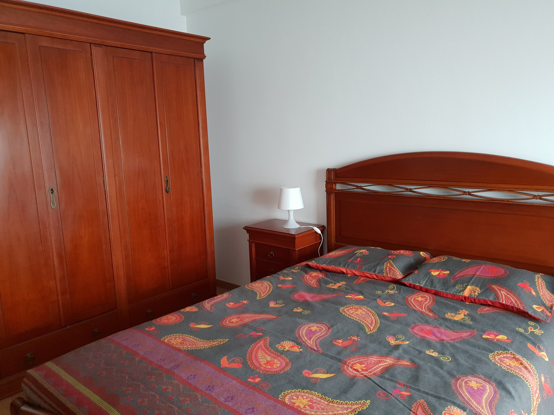 Bed with wardrobe and lamp