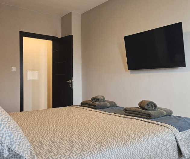 Bedroom with TV and door
