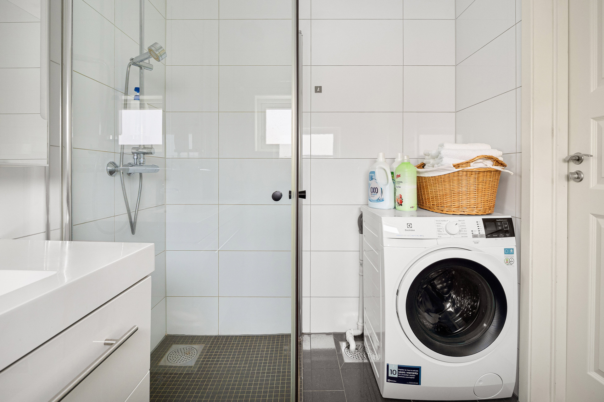Bathroom with shower and washing machine