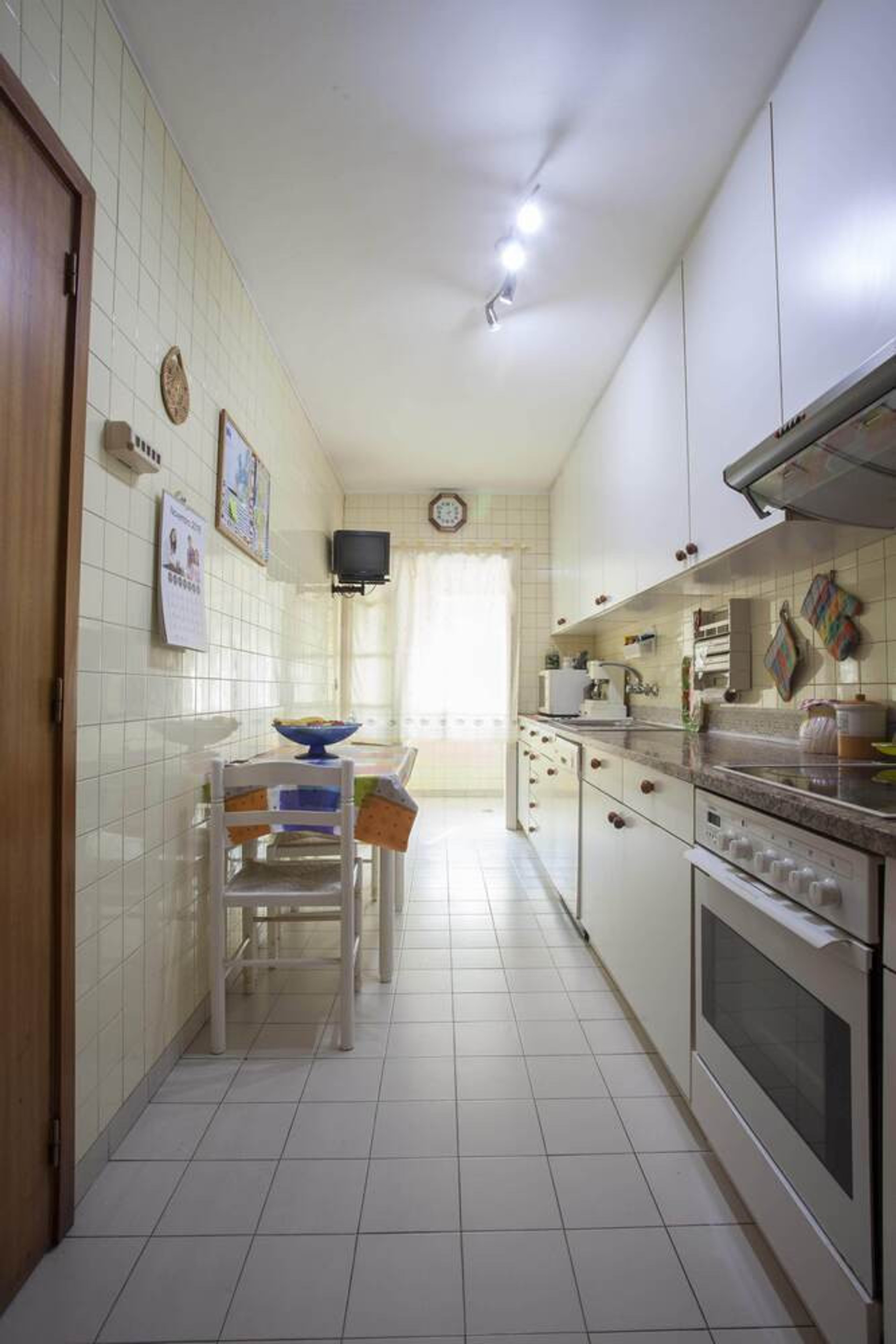 Narrow kitchen with dining table
