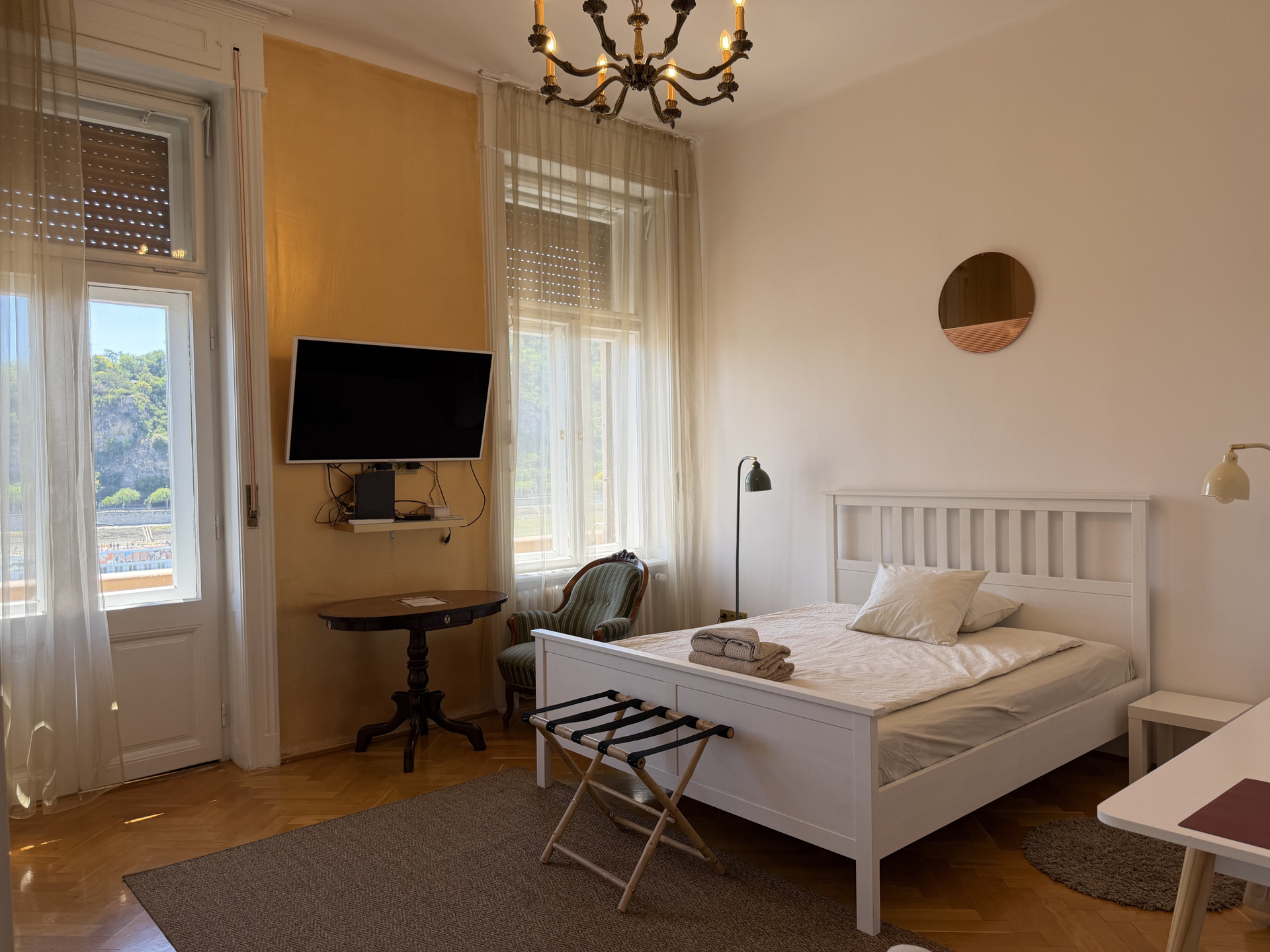 Bright bedroom with double bed TV