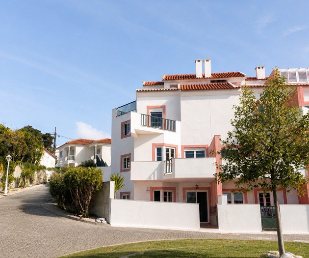 Pink-trimmed building exterior with lawn