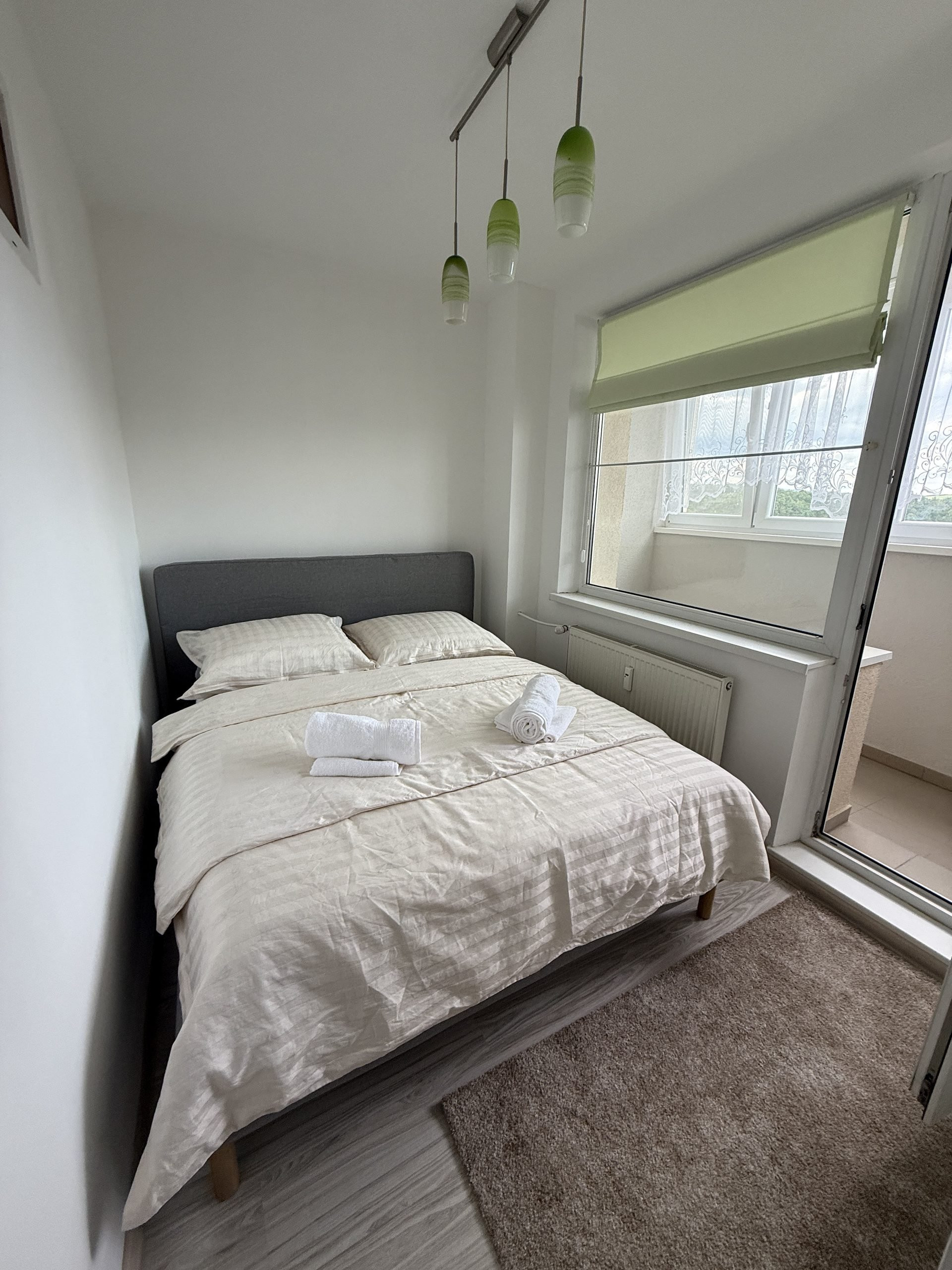 Bedroom with double bed and balcony