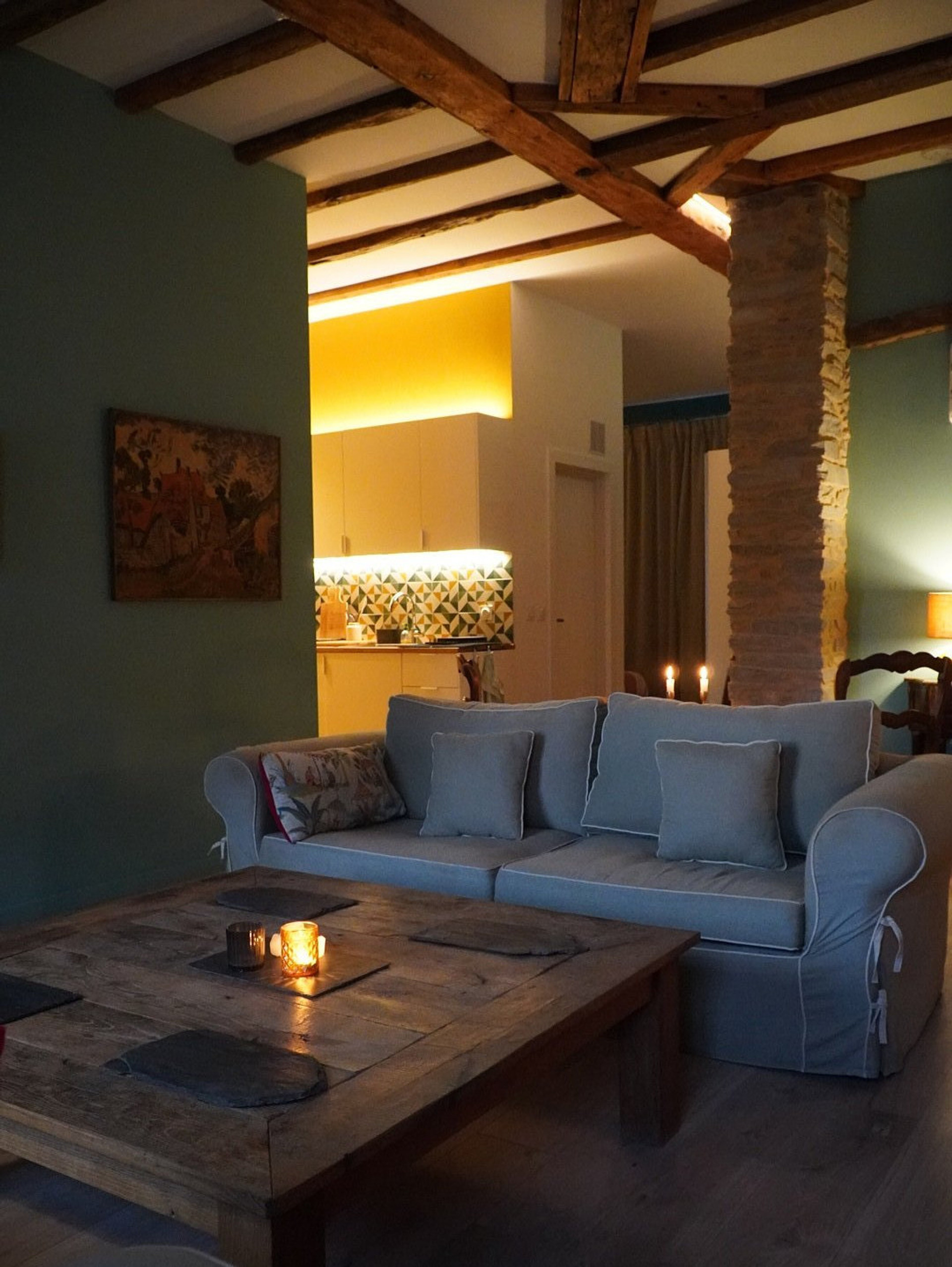 Open-plan studio apartment with rustic beams, stone details, and warm ambient lighting. A thoughtfully designed space in Saint-Yrieix-la-Perche—ideal for couples or anyone travelling solo, and a perfect base for exploring the Limousin region.