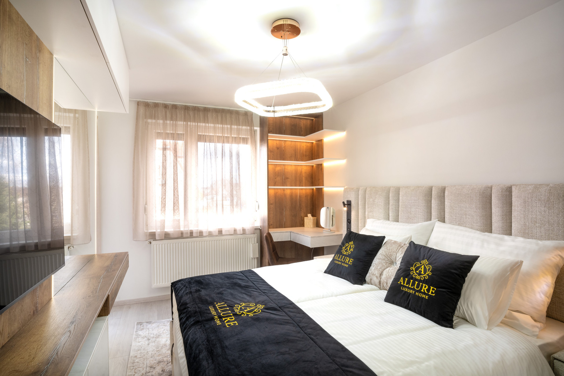 Elegant bedroom with a private balcony, Smart TV, and a bed featuring built-in ambient lighting. Equipped with a Bluetooth radio and integrated charger for ultimate convenience.