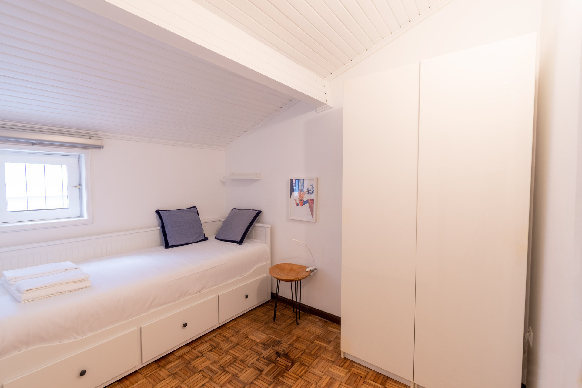 Small bedroom with single bed wardrobe