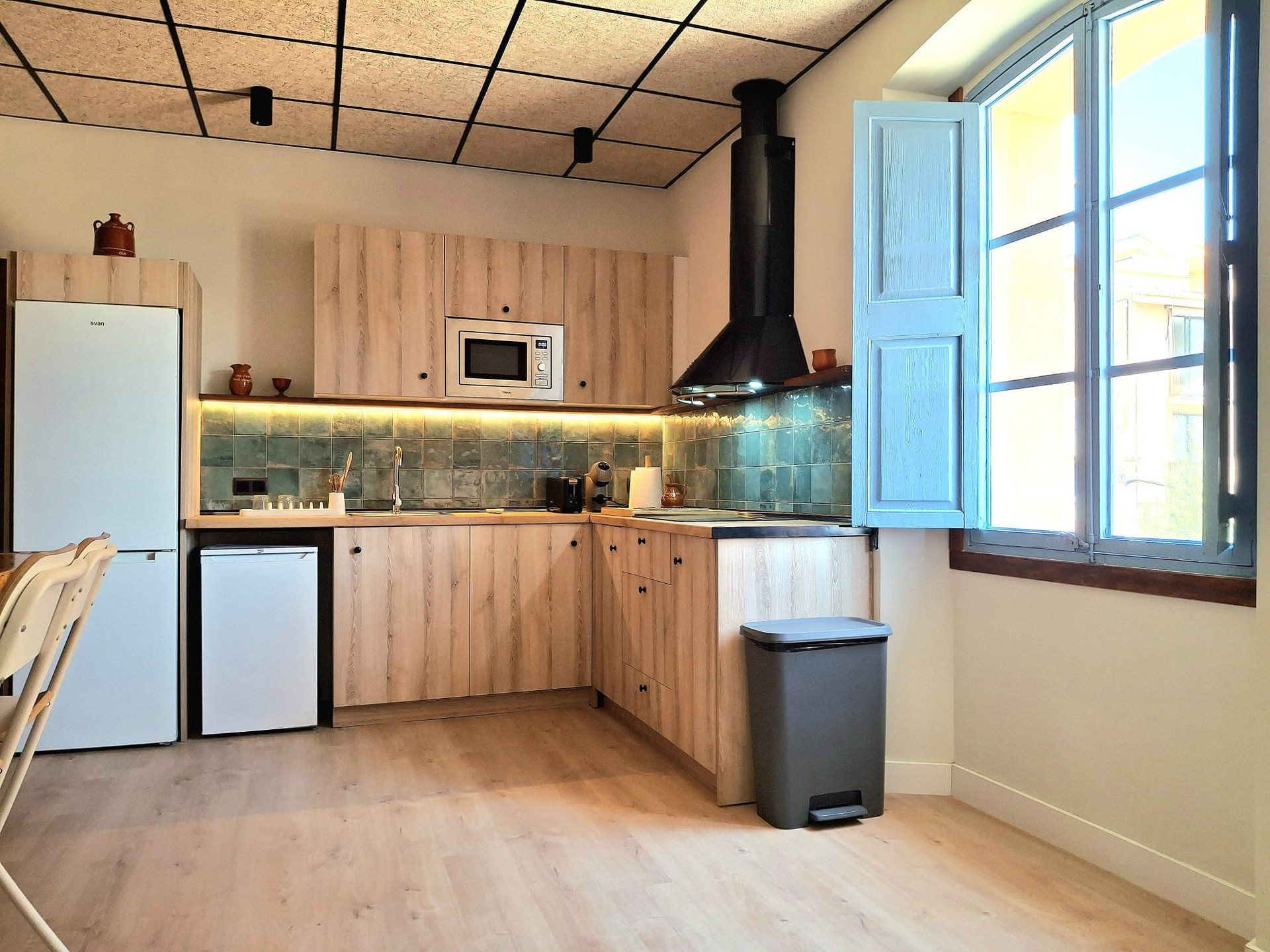 Kitchen with green tile backsplash