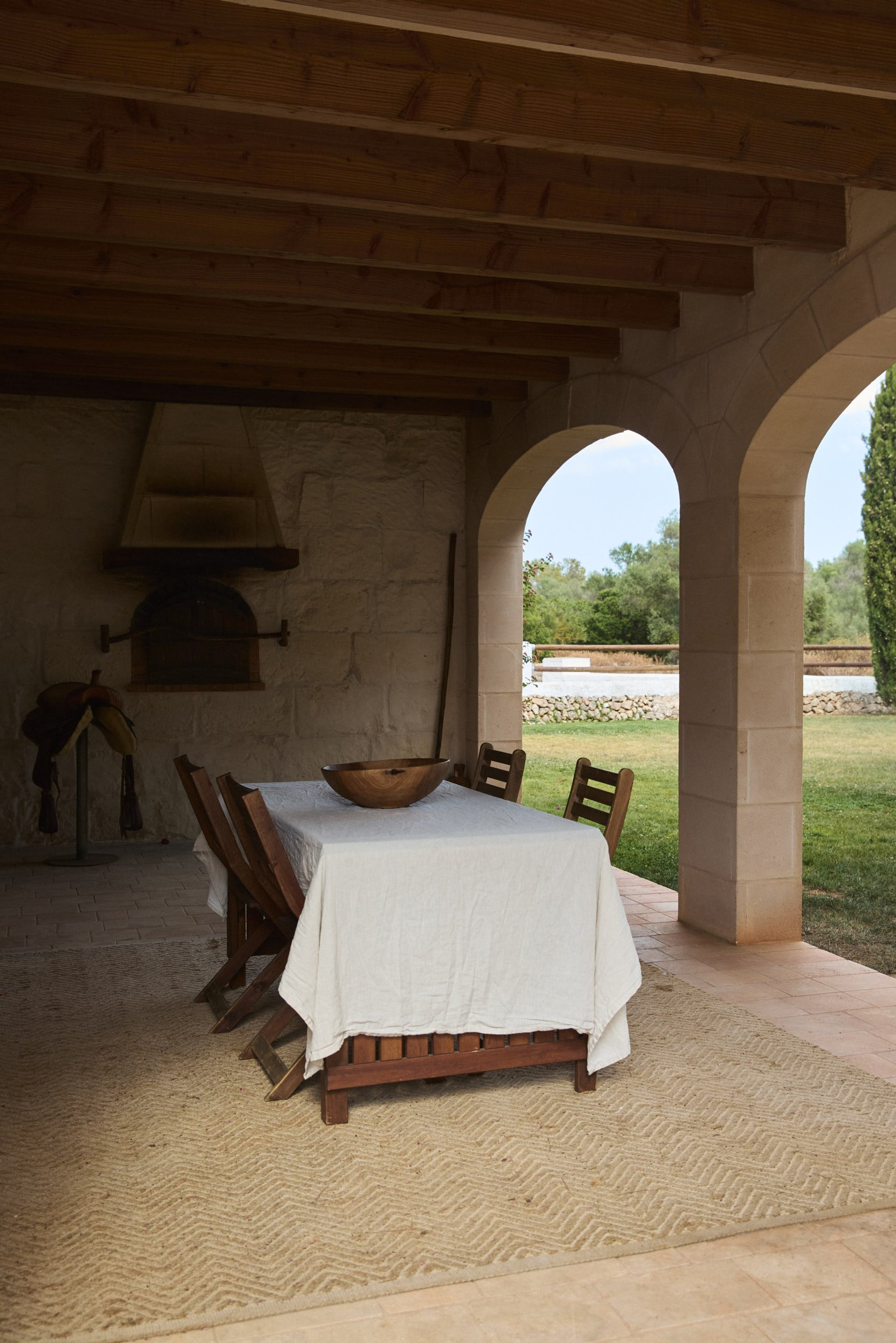 Covered terrace dining with stone arch