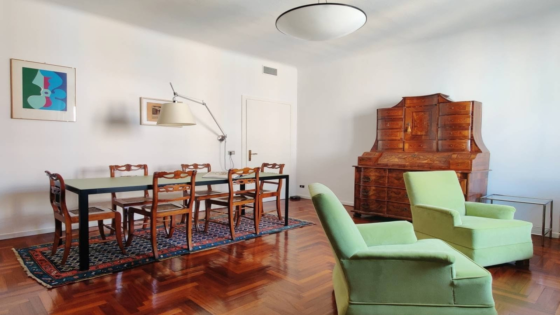 The Tolomeo lamp, the trumeau, the dining table. Three different centuries in one room