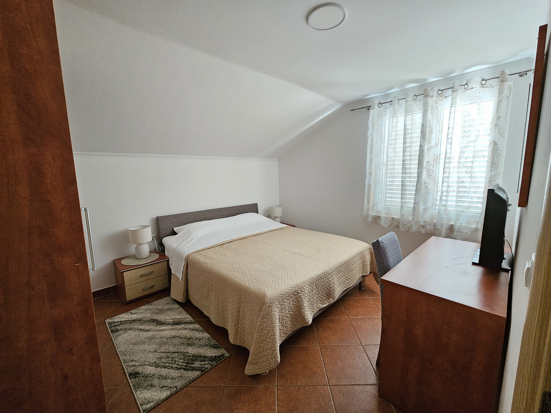 Bedroom with desk and window