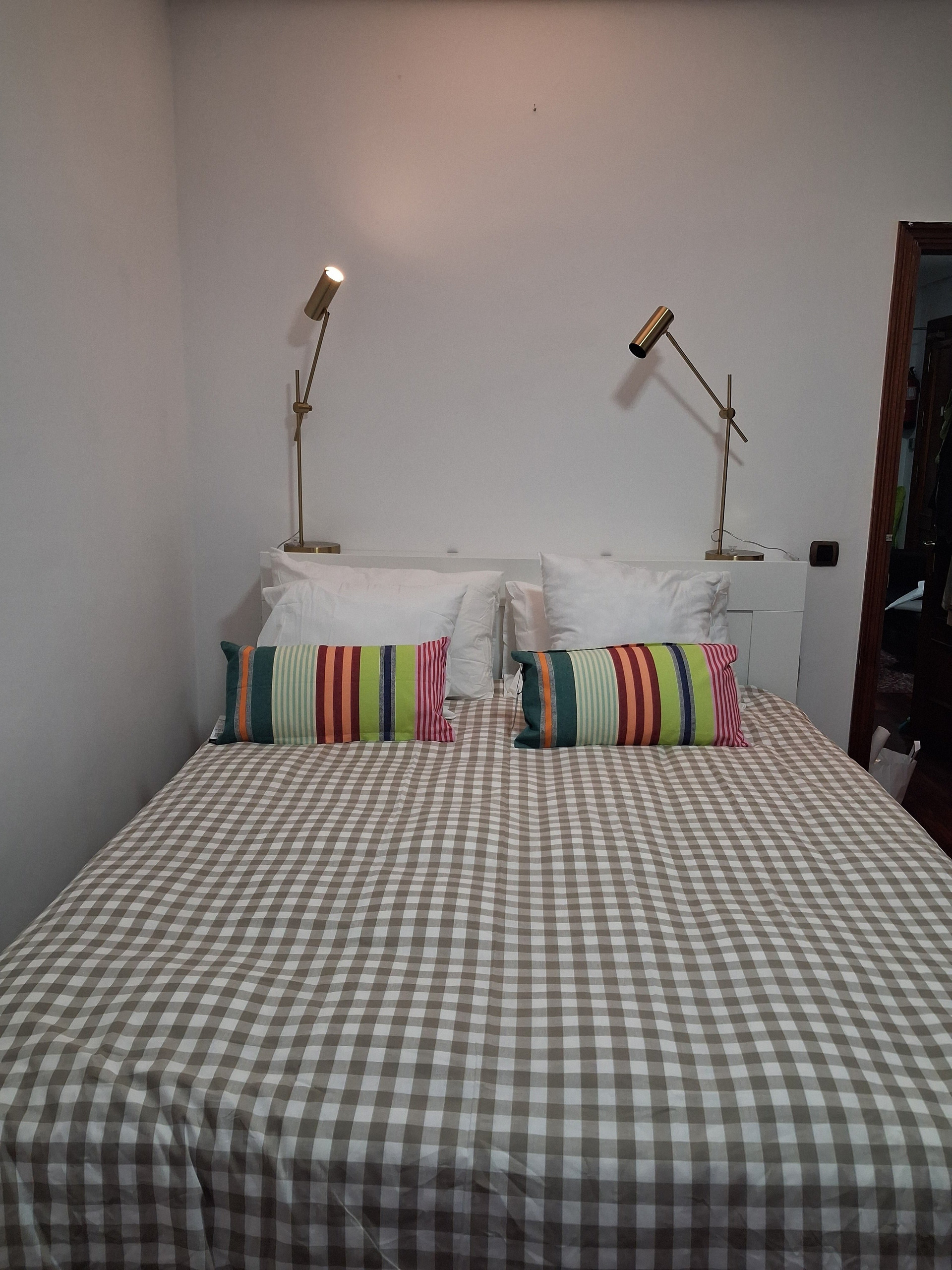 Double bed with striped cushions