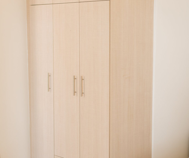 Wooden wardrobe in bedroom