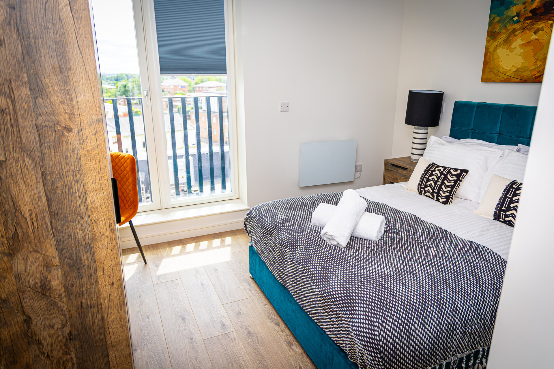 Teal bed with balcony view