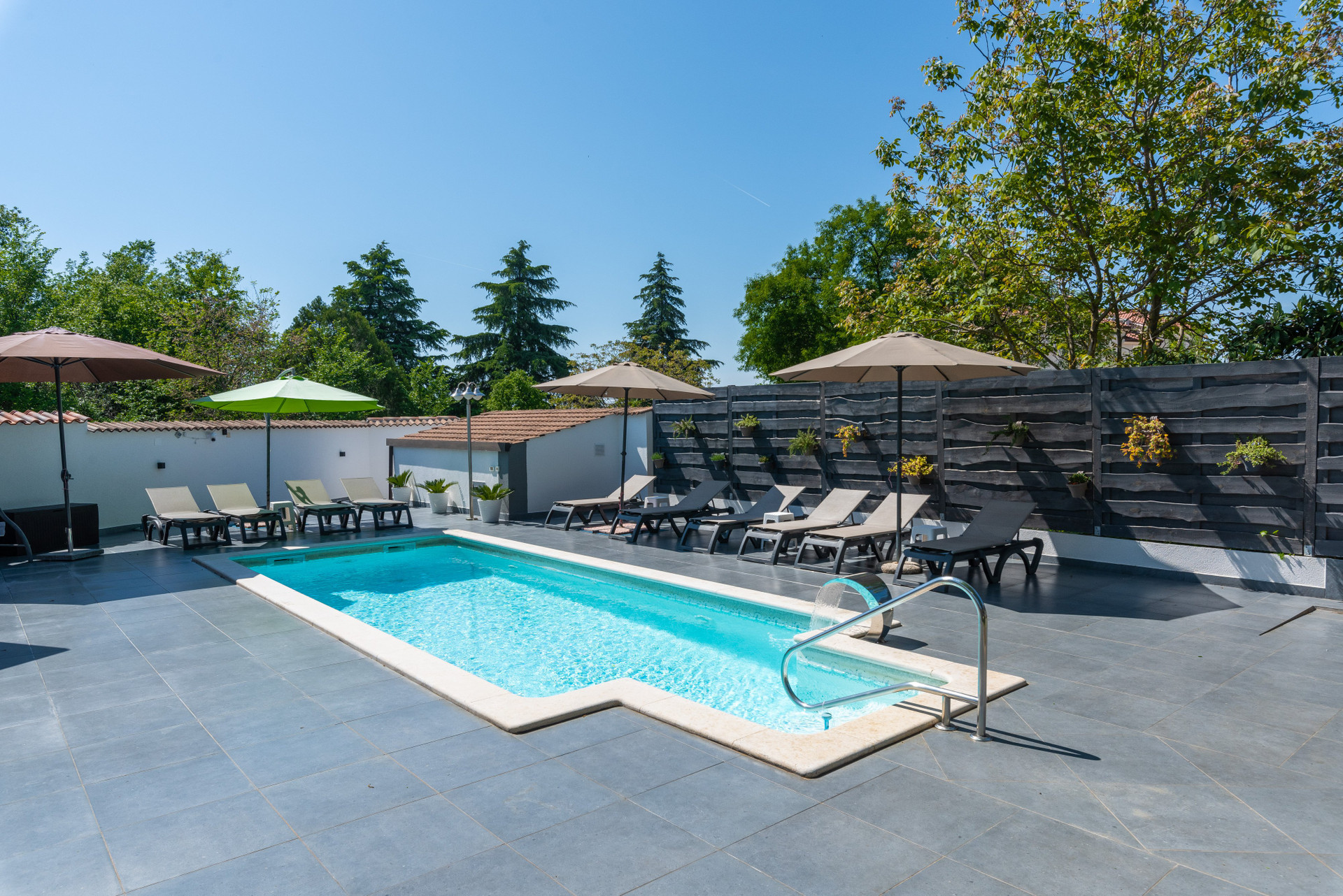 Outdoor pool with loungers sunny
