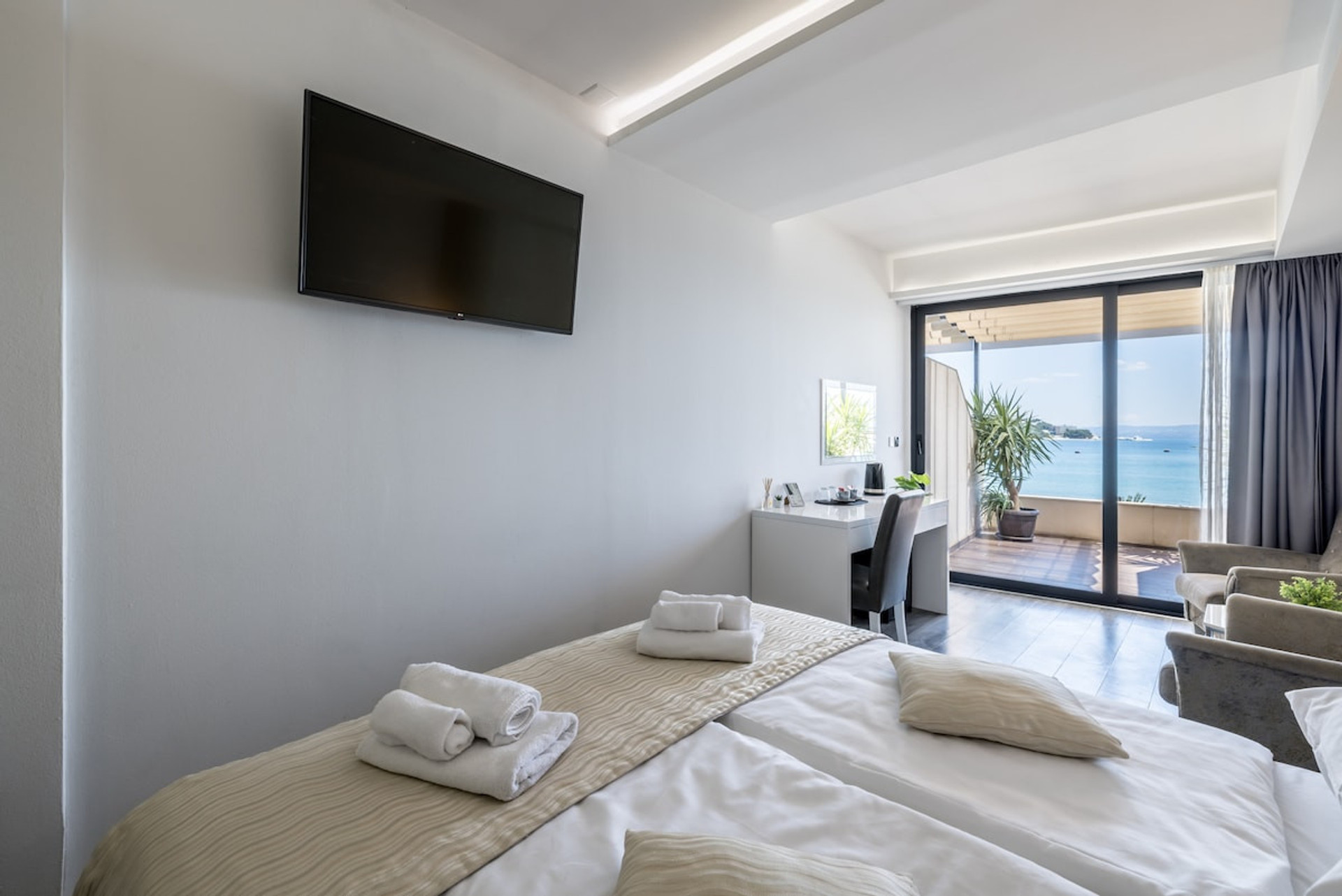A comfortable bed facing a flat-screen TV.