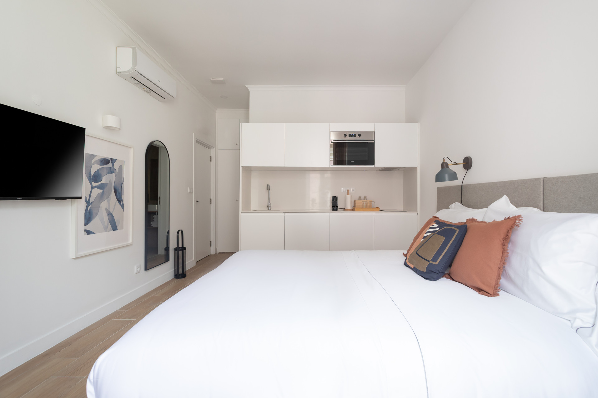 Studio bed facing kitchenette and TV