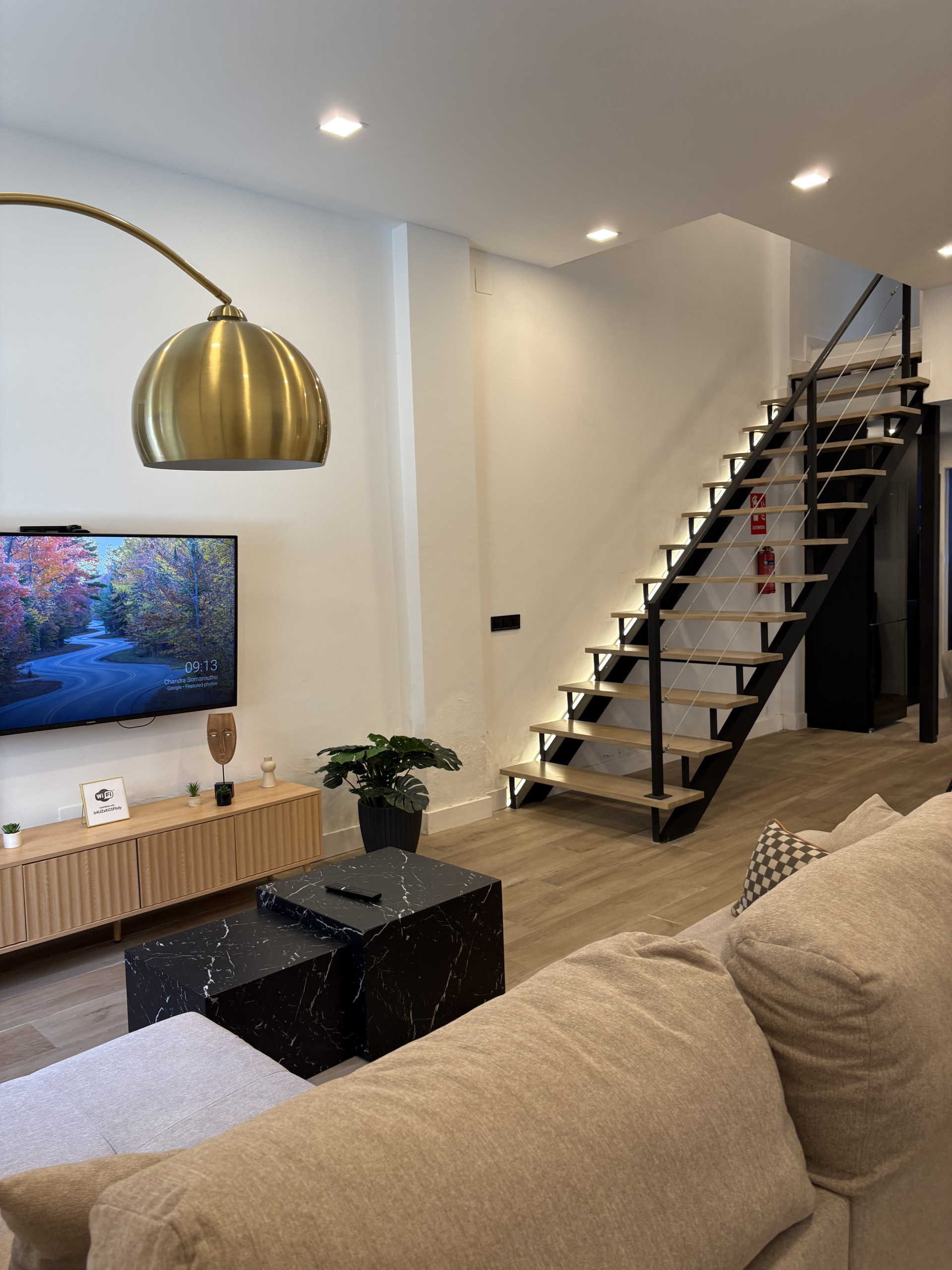 Living room with TV and staircase