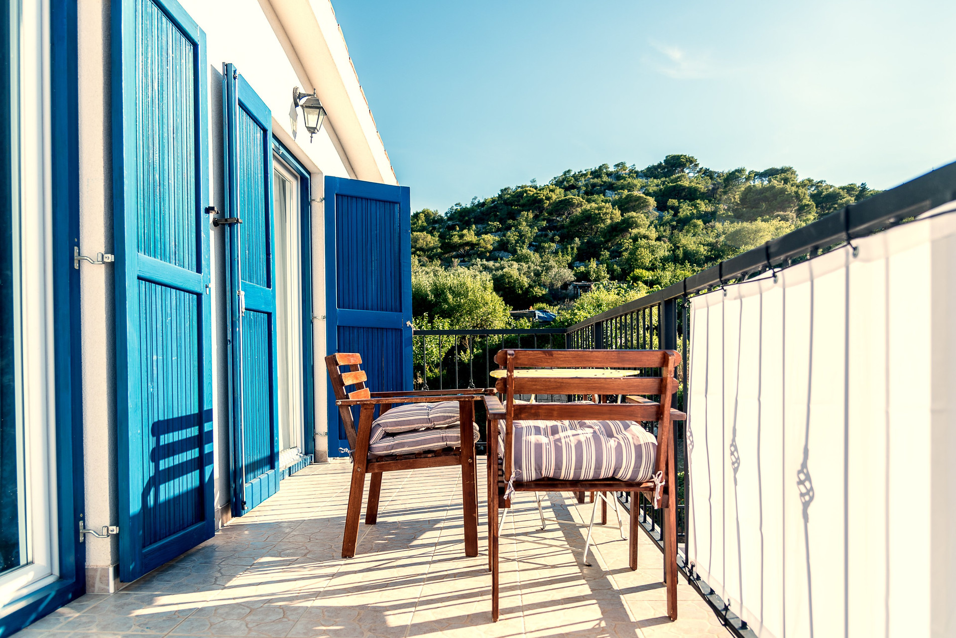Balcony with wooden chairs
