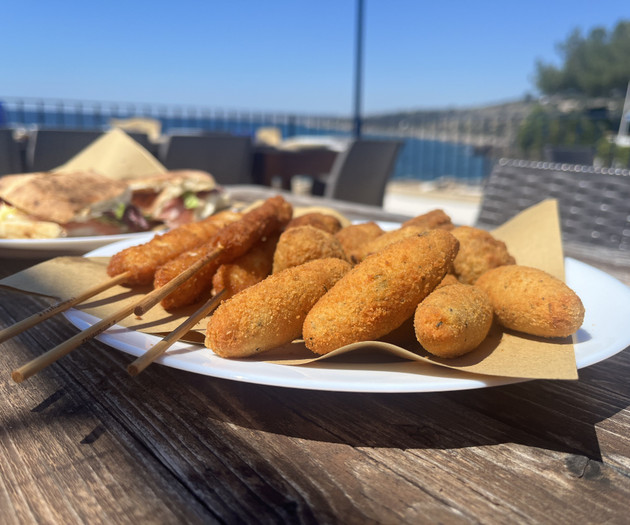 Fried snacks on seaside table