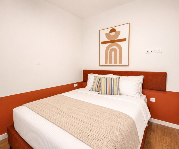 Cozy bedroom with orange headboard