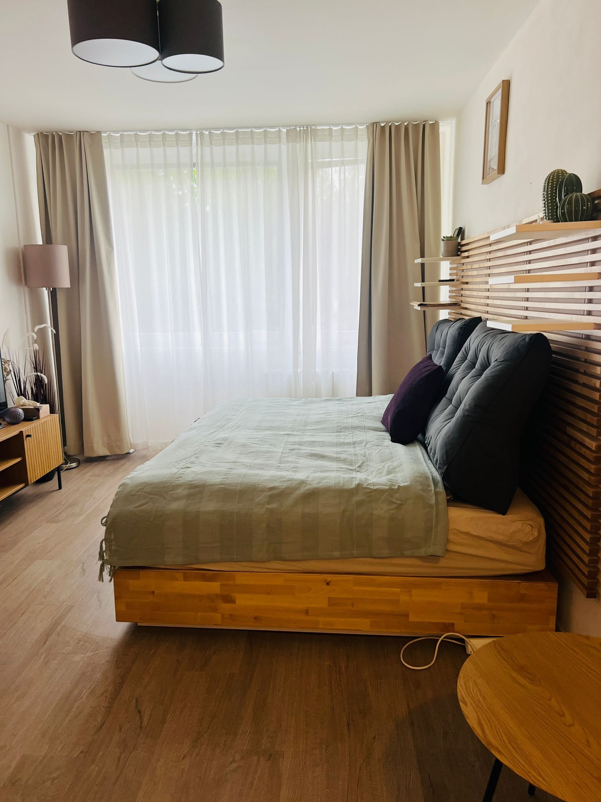 Cozy bedroom with wooden bed frame