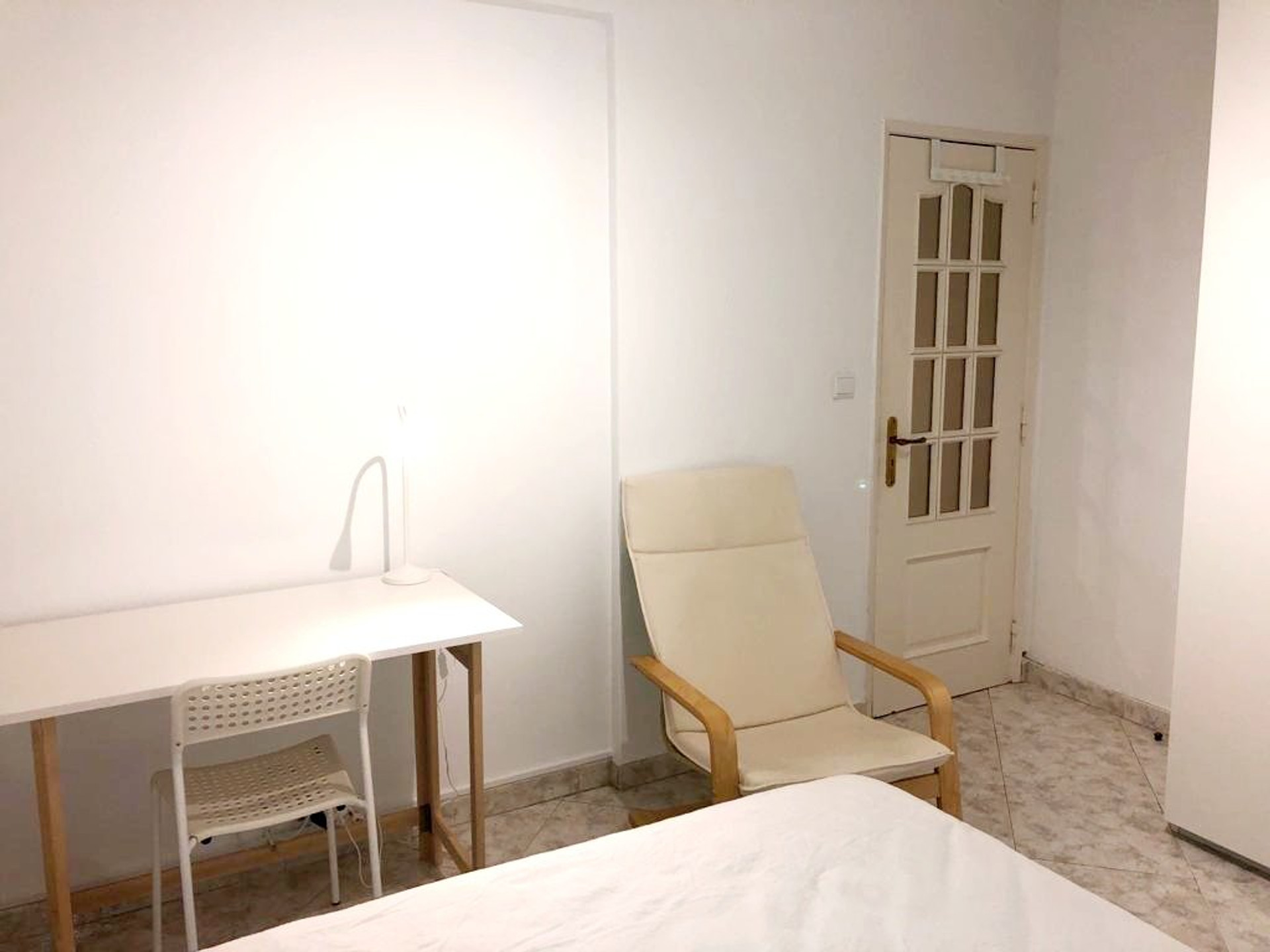 Bedroom with desk and armchair
