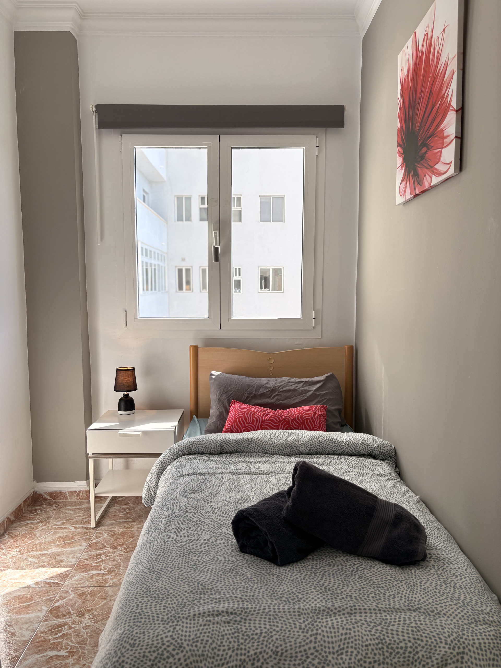 Single bedroom with window and artwork