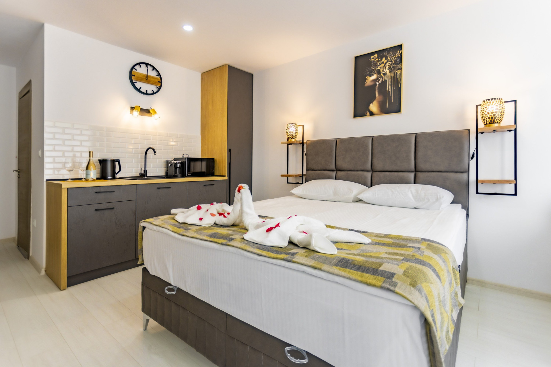Bed and kitchenette with clock