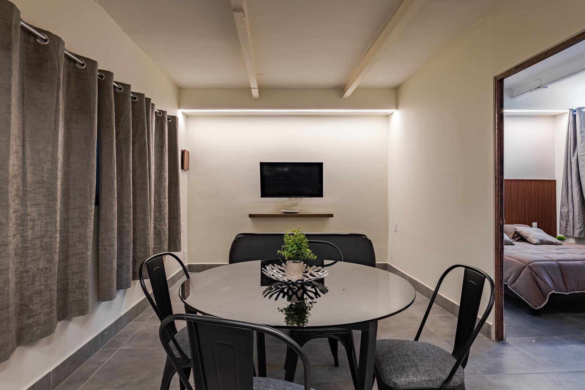 Dining area with TV and bedroom view
