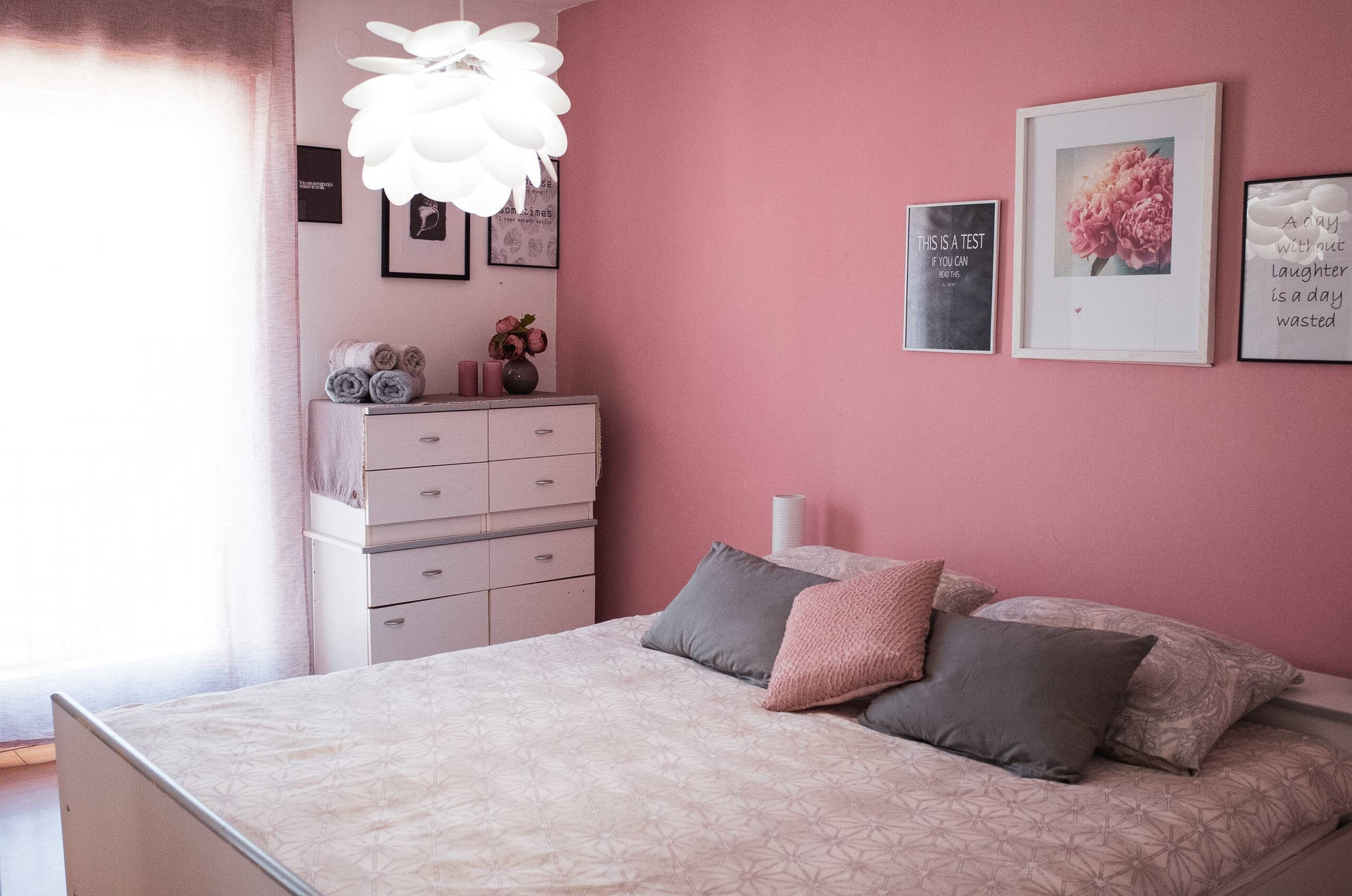 Pink double bedroom with artwork