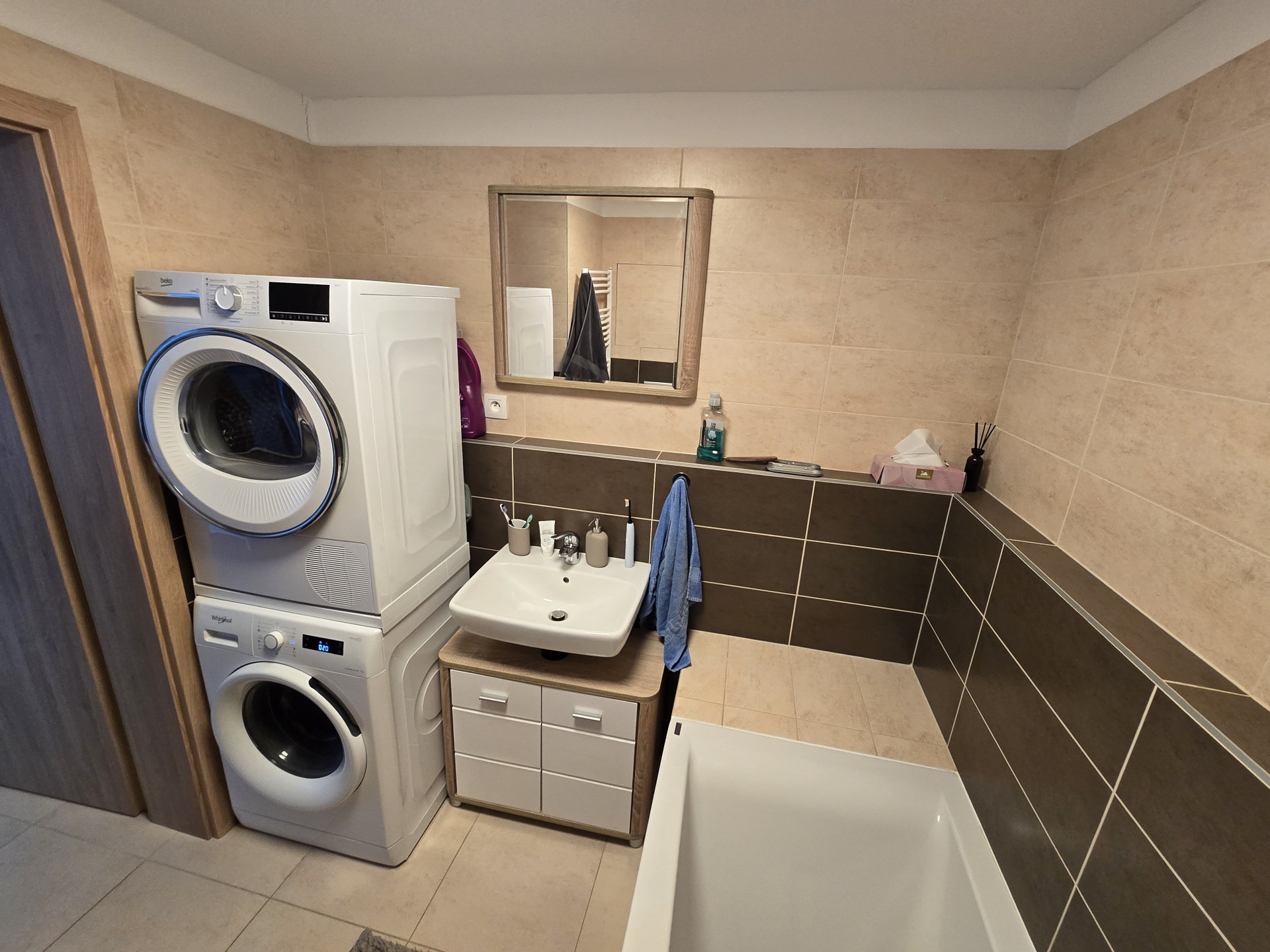 Bathroom with washer and sink