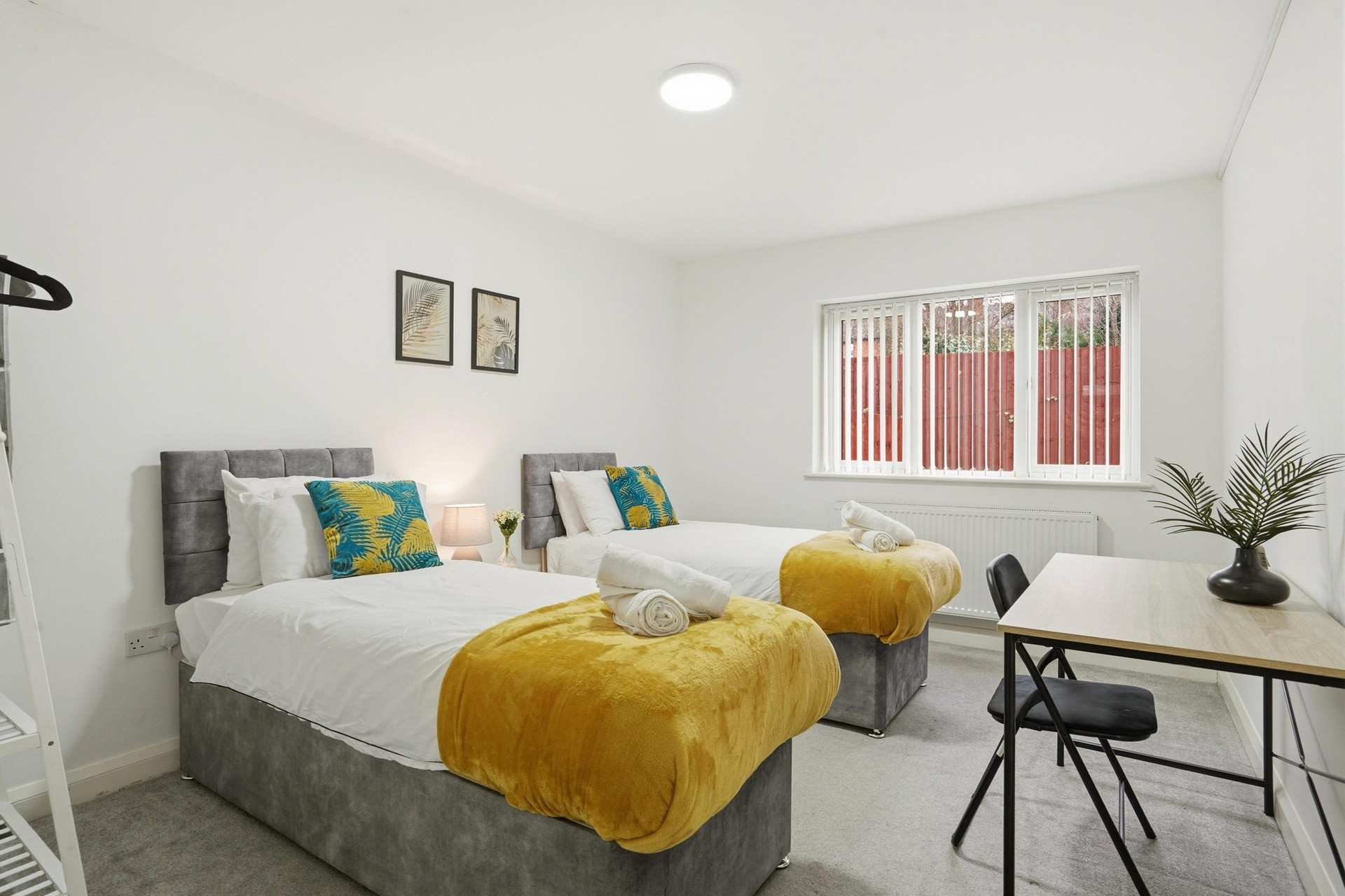 Twin bedroom with window and desk