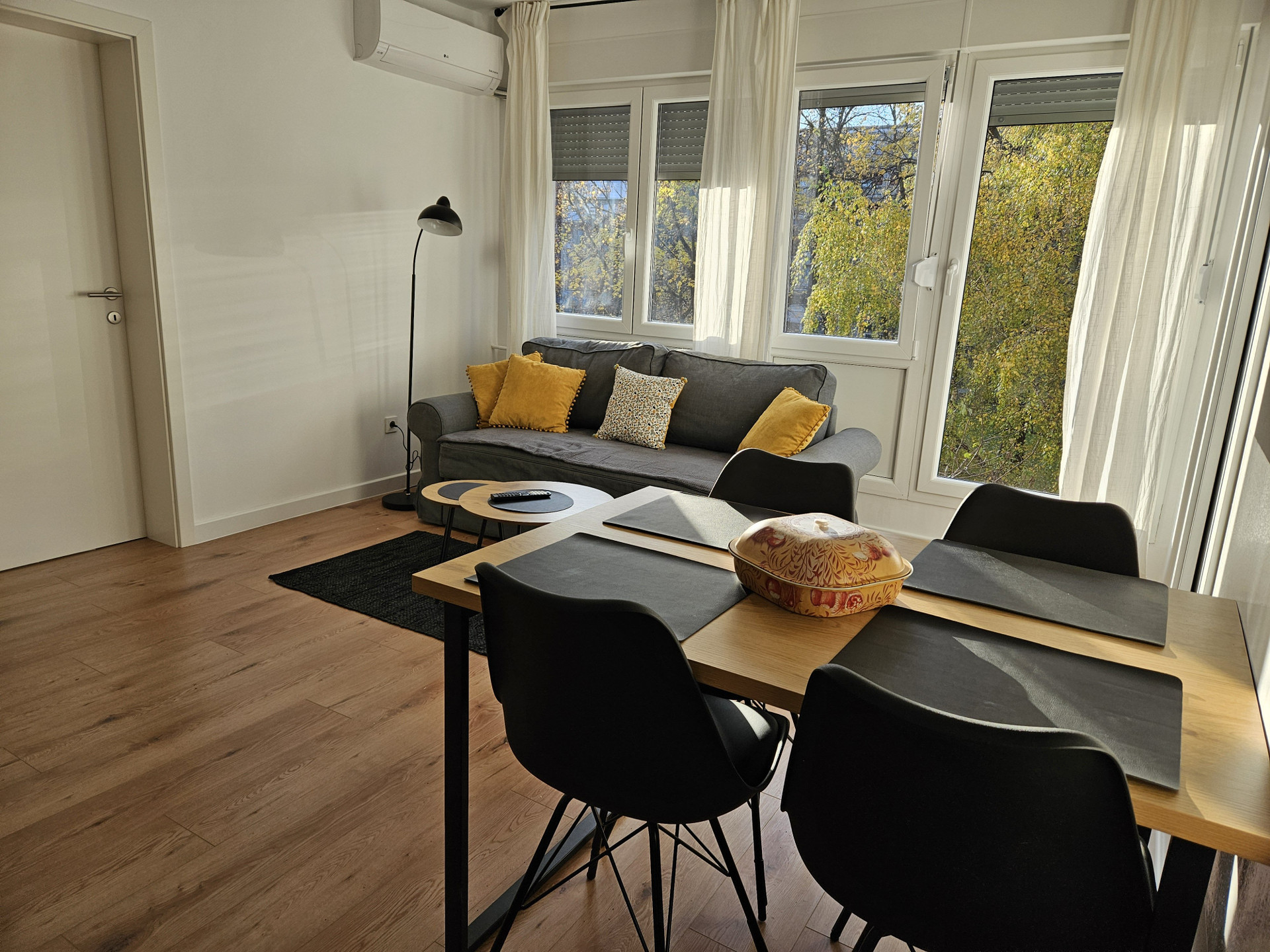 Dining table and sofa with windows