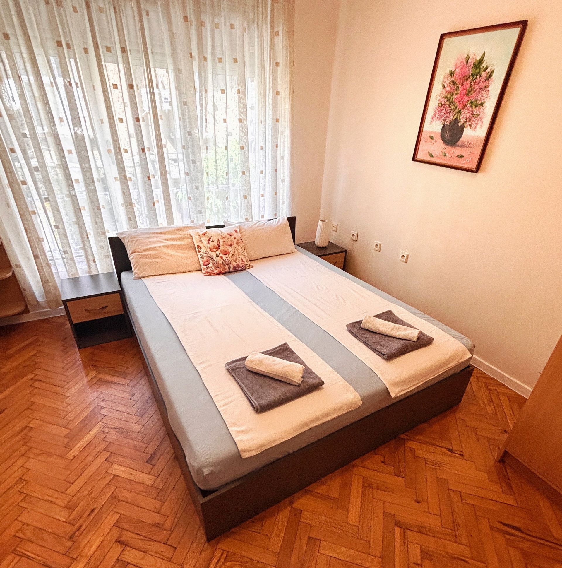 Bedroom with floral art and window