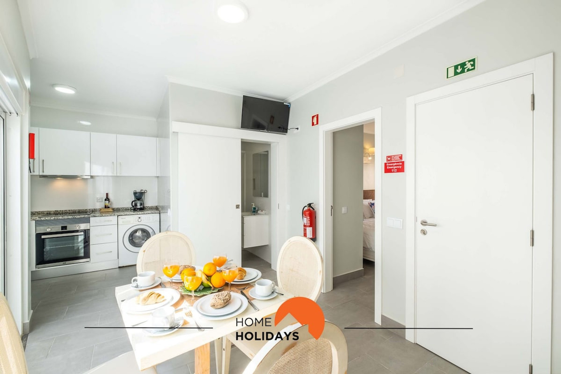 The living room is open, containing a dining area,