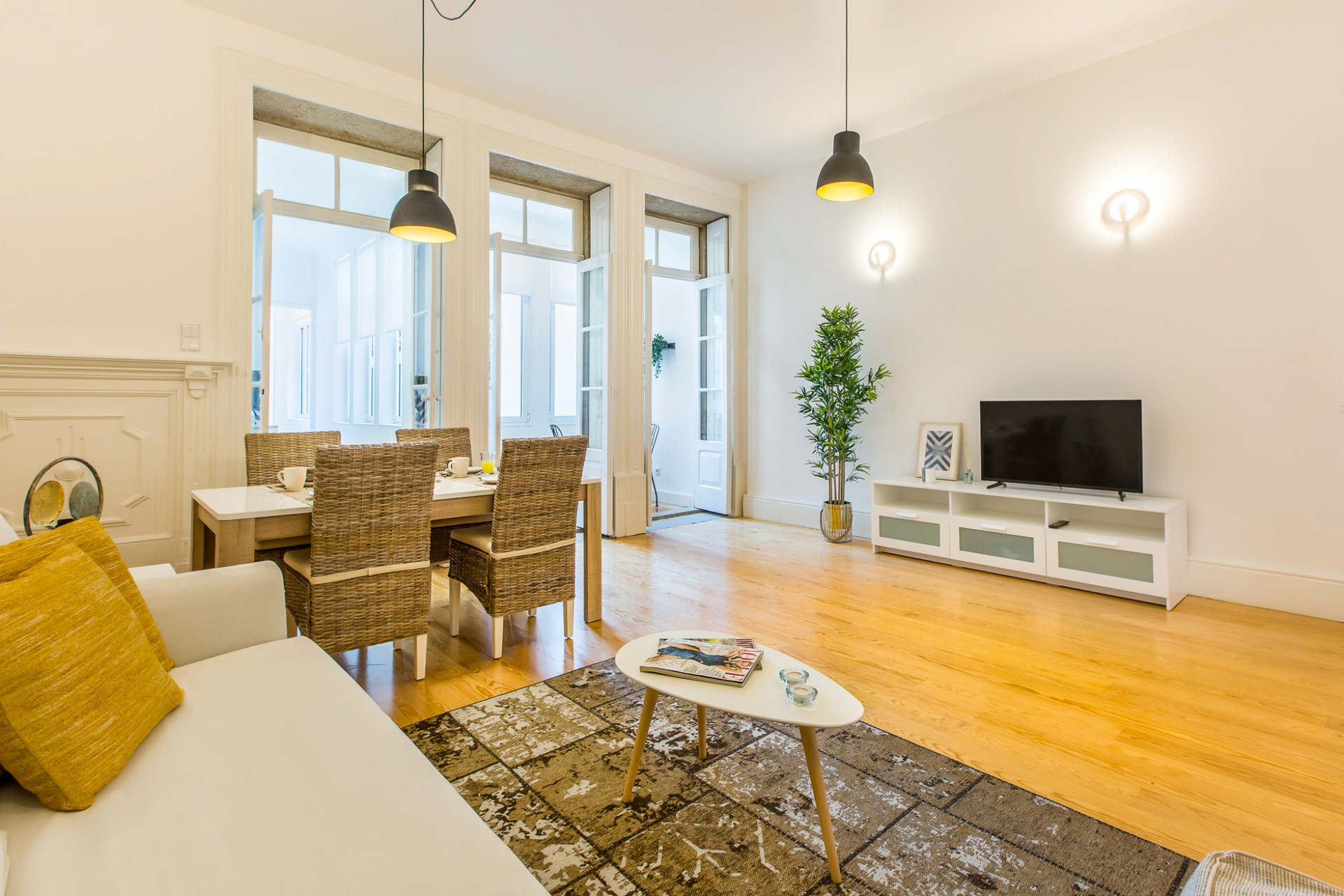 Living Room with TV, Sofa and Dining Table