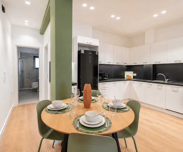 Dining table near kitchen and bathroom