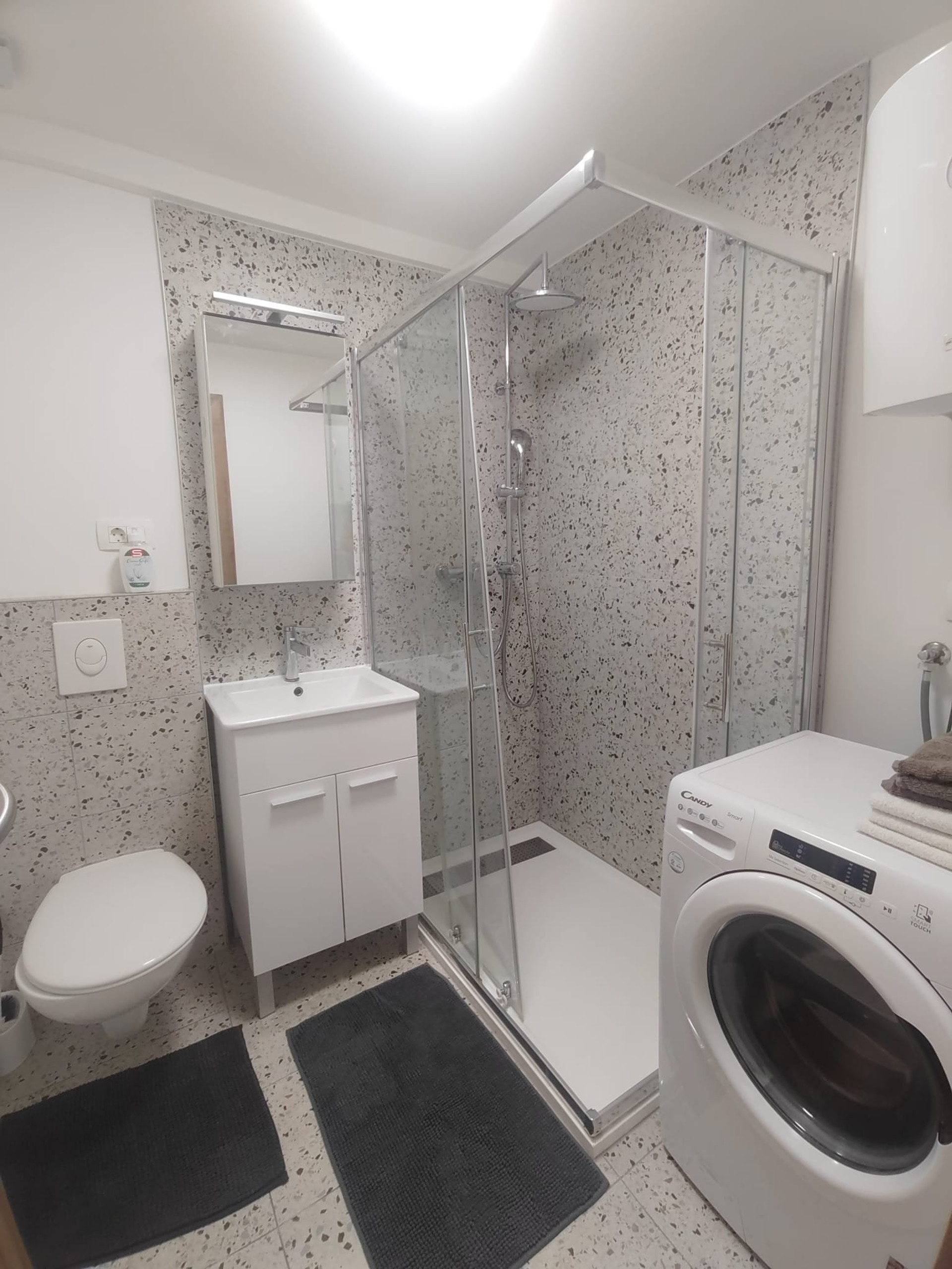 Bathroom with shower and laundry