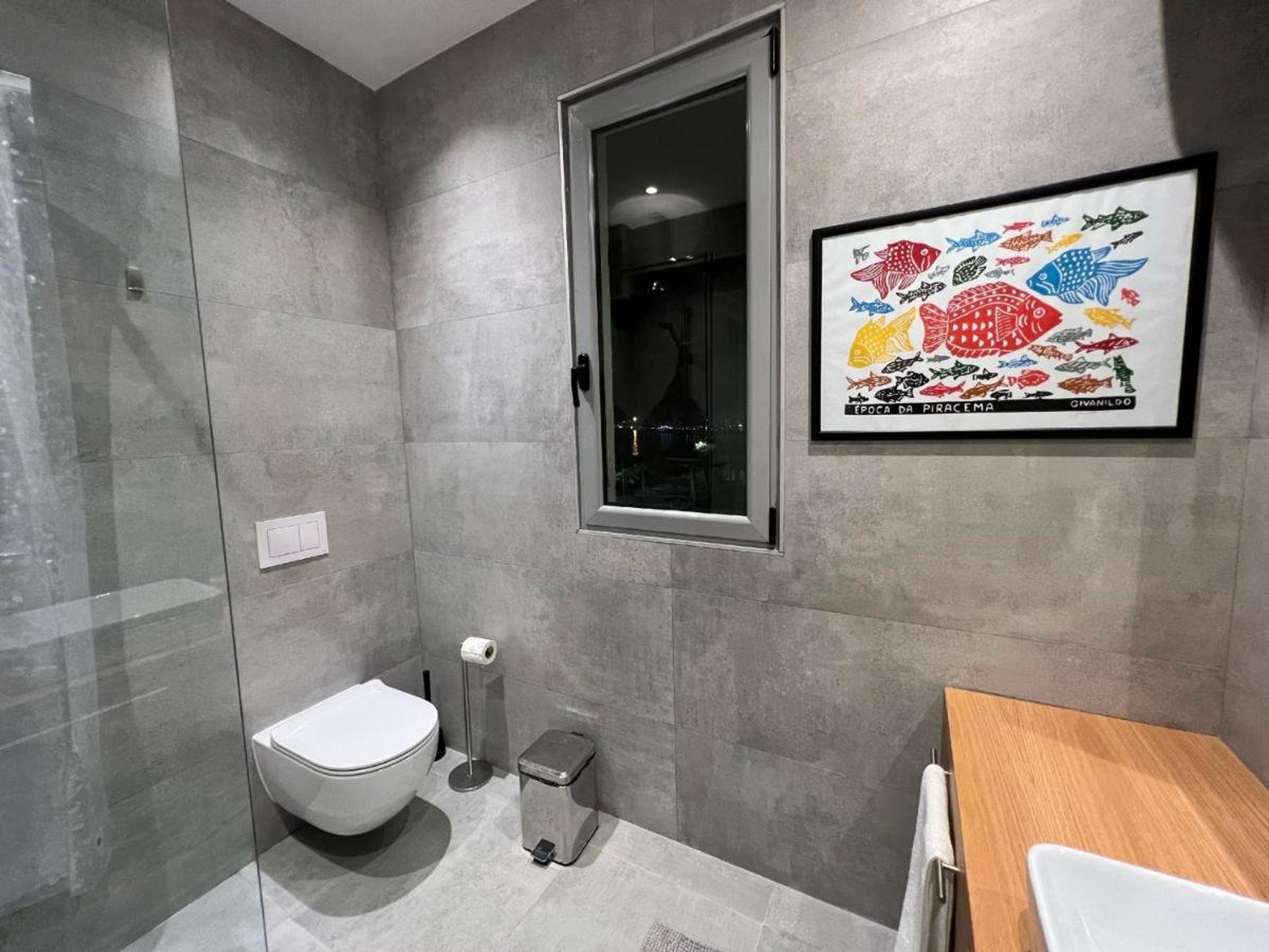 Gray tiled bathroom with toilet
