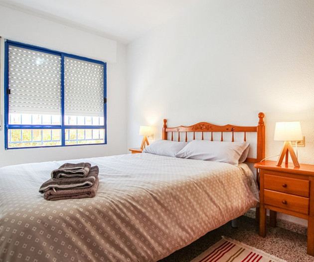 Bedroom with blue window