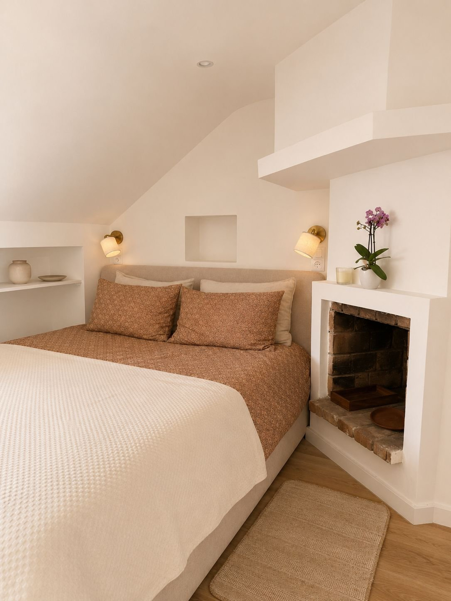 Cozy bedroom with fireplace and sconces