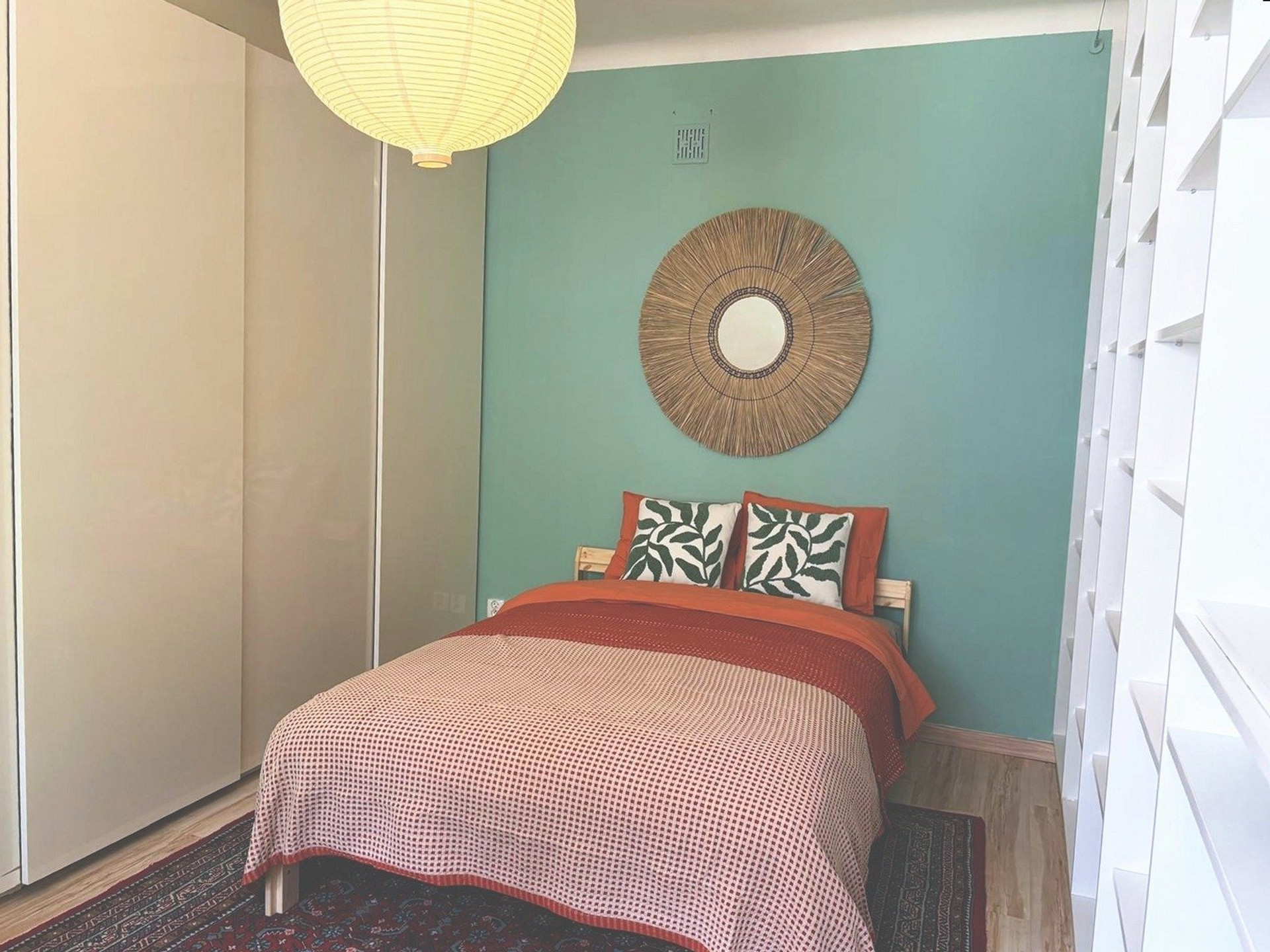 Cozy bedroom with teal accent wall