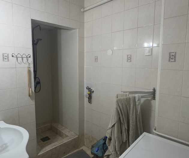 Bathroom with shower and washer