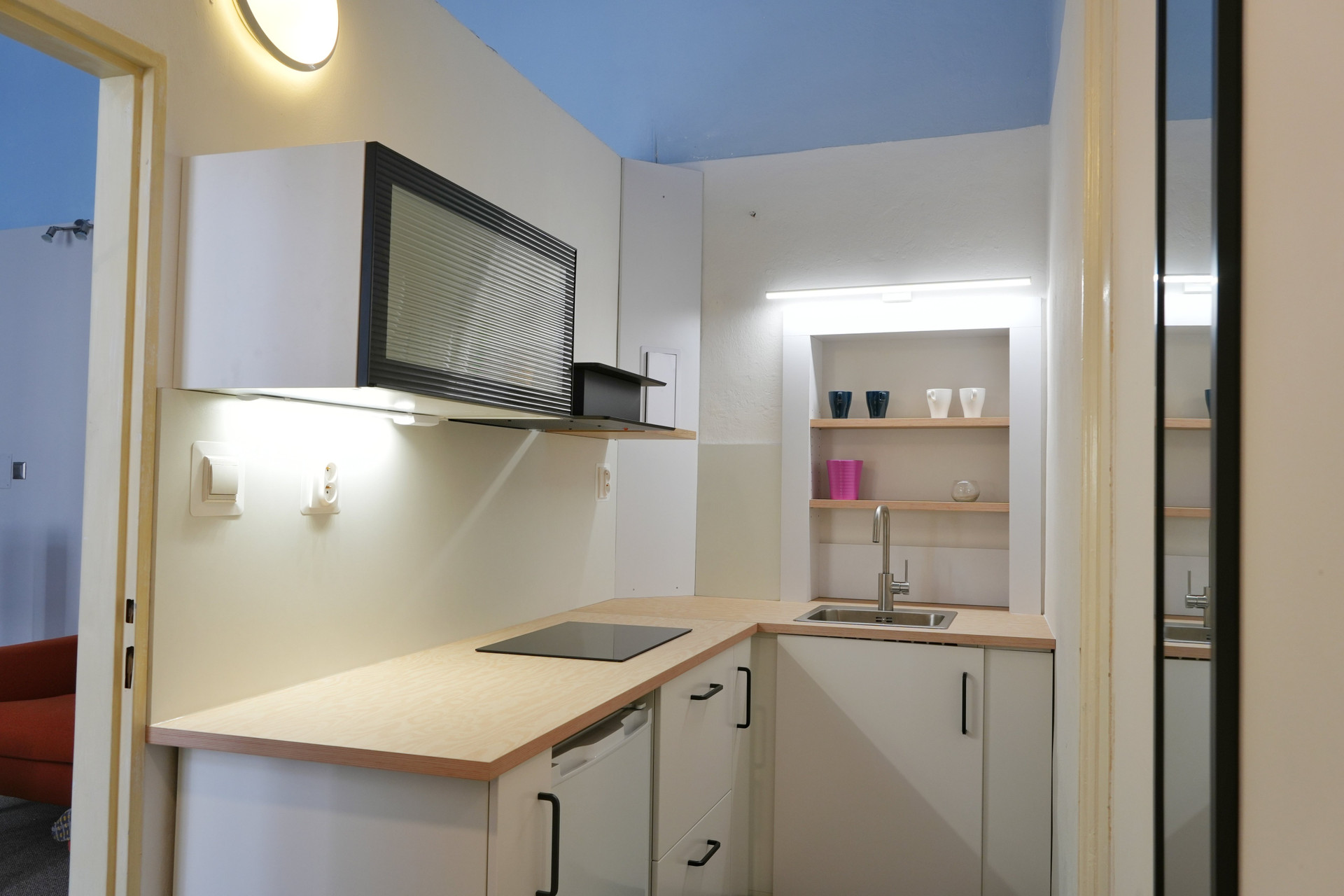 Compact kitchen with sink and shelves